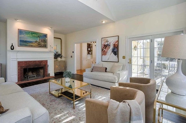 living room with a fireplace and wood finished floors