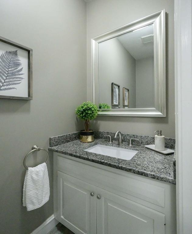 bathroom with visible vents, vanity, and baseboards