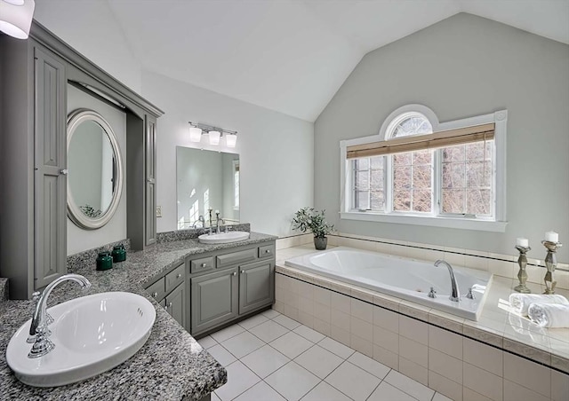 full bathroom featuring double vanity, tile patterned floors, a sink, and lofted ceiling