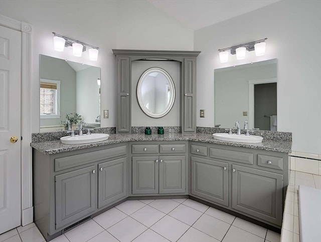 bathroom with double vanity, tile patterned flooring, and a sink