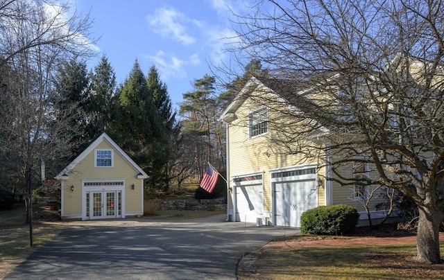 exterior space with aphalt driveway and french doors