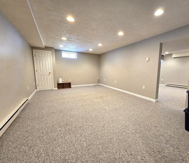 basement with carpet, recessed lighting, and baseboard heating