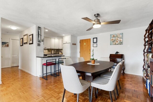 dining space featuring baseboards, a ceiling fan, and recessed lighting