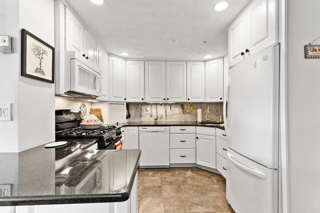 kitchen with recessed lighting, white appliances, a sink, and white cabinetry