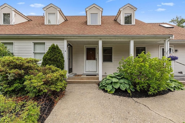 10 Enterprise St Unit 2, Duxbury, MA 02332 - cape cod house featuring roof with shingles and covered porch