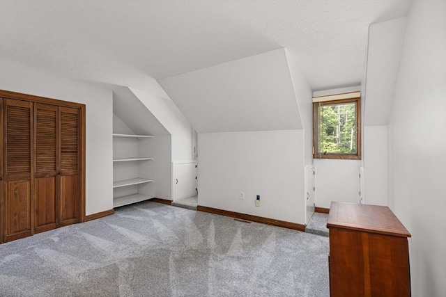 10 Enterprise St Unit 2, Duxbury, MA 02332 - additional living space with vaulted ceiling, carpet floors, built in features, and a textured ceiling