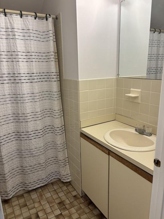 10 Enterprise St Unit 2, Duxbury, MA 02332 - bathroom featuring vanity, tile walls, and a shower with shower curtain