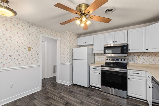 10 Enterprise St Unit 2, Duxbury, MA 02332 - kitchen featuring stainless steel appliances, a wainscoted wall, light countertops, dark wood-style flooring, and wallpapered walls