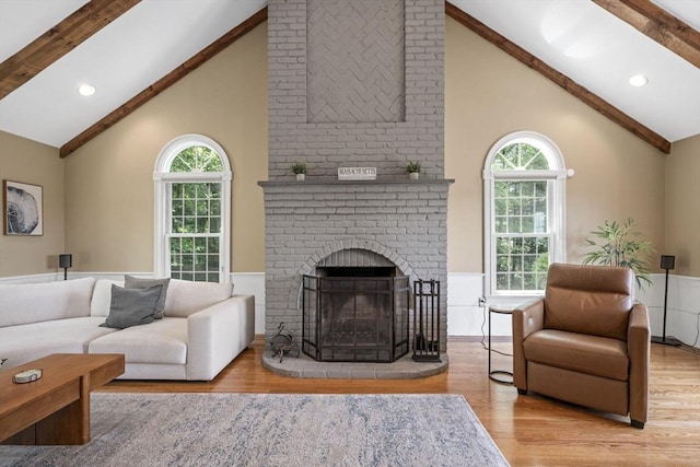 5 John Matthew Rd, Hopkinton, MA 01748 - living room with wood finished floors, beam ceiling, high vaulted ceiling, a wainscoted wall, and a fireplace
