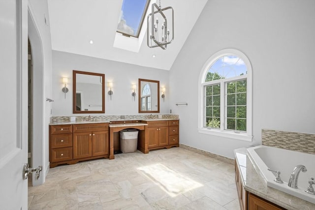5 John Matthew Rd, Hopkinton, MA 01748 - bathroom featuring double vanity, a garden tub, high vaulted ceiling, and a skylight