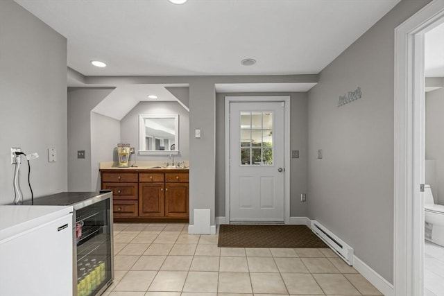 5 John Matthew Rd, Hopkinton, MA 01748 - kitchen with a baseboard radiator, brown cabinets, light tile patterned floors, recessed lighting, and light countertops