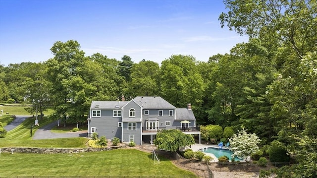 5 John Matthew Rd, Hopkinton, MA 01748 - rear view of property with a wooden deck, a lawn, an outdoor pool, a chimney, and a view of trees