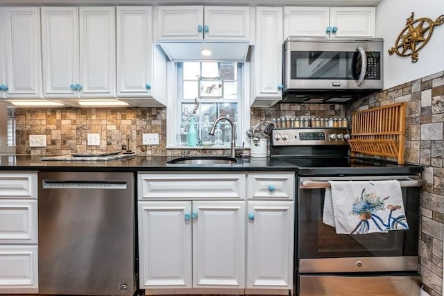 kitchen featuring a sink, decorative backsplash, white cabinets, and appliances with stainless steel finishes
