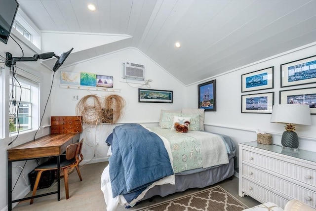 bedroom with recessed lighting, wood finished floors, lofted ceiling, and an AC wall unit