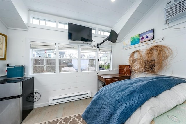 bedroom featuring multiple windows, vaulted ceiling, wood finished floors, and a baseboard heating unit