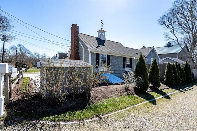 view of side of home with a chimney