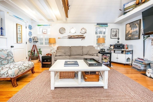 living room with light wood-style flooring and beam ceiling