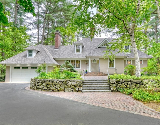 15 Blackburnian Rd, Lincoln, MA 01773 - view of front facade with roof with shingles, driveway, and a garage
