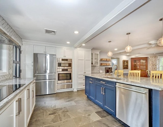 15 Blackburnian Rd, Lincoln, MA 01773 - kitchen featuring appliances with stainless steel finishes, blue cabinets, a sink, white cabinetry, and recessed lighting