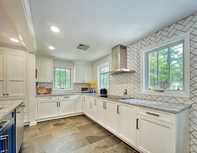 15 Blackburnian Rd, Lincoln, MA 01773 - kitchen with wall chimney range hood, decorative backsplash, white cabinets, stainless steel dishwasher, and light stone counters