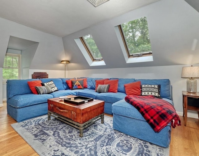 15 Blackburnian Rd, Lincoln, MA 01773 - living room featuring a skylight, wood finished floors, and lofted ceiling
