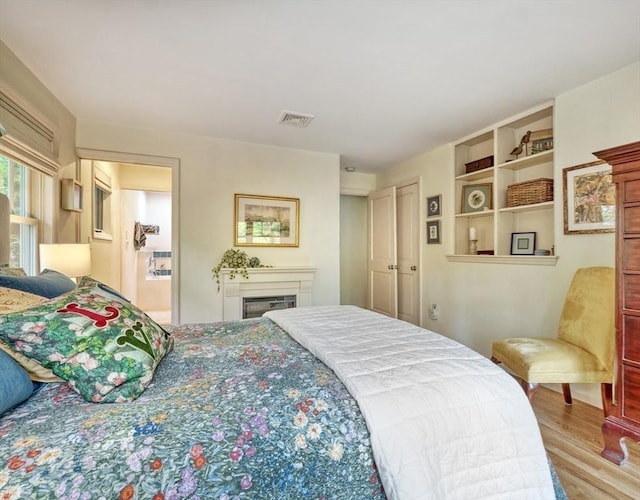 15 Blackburnian Rd, Lincoln, MA 01773 - bedroom with wood finished floors and a glass covered fireplace