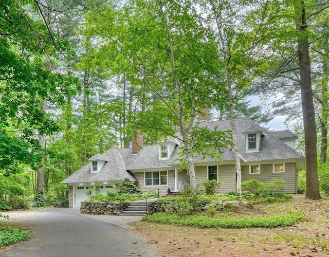 15 Blackburnian Rd, Lincoln, MA 01773 - cape cod home with asphalt driveway, roof with shingles, a chimney, and a garage