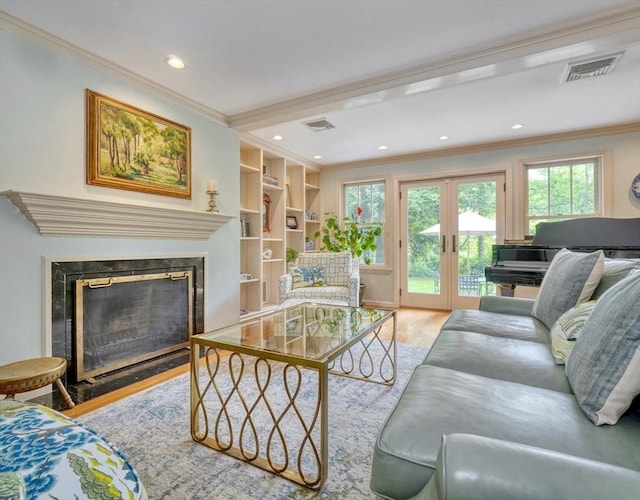 15 Blackburnian Rd, Lincoln, MA 01773 - living room with crown molding, wood finished floors, healthy amount of natural light, a high end fireplace, and recessed lighting