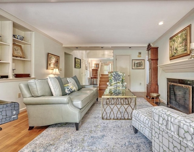 15 Blackburnian Rd, Lincoln, MA 01773 - living area featuring wood finished floors, stairs, a fireplace, crown molding, and baseboards