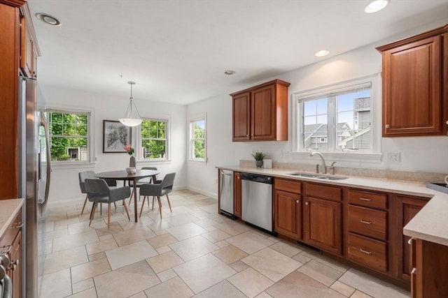 32 Old Framingham Rd Unit 20, Sudbury, MA 01776 - kitchen with appliances with stainless steel finishes, plenty of natural light, light countertops, brown cabinets, and recessed lighting