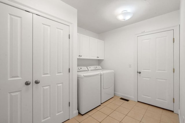 32 Old Framingham Rd Unit 20, Sudbury, MA 01776 - laundry room with washer and clothes dryer, cabinet space, and light tile patterned floors