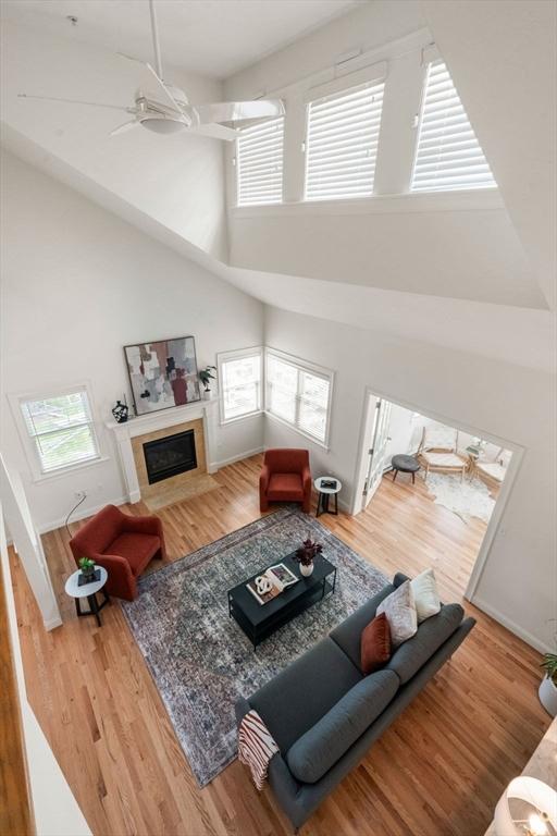 32 Old Framingham Rd Unit 20, Sudbury, MA 01776 - living area with a high ceiling, a fireplace, wood finished floors, and ceiling fan