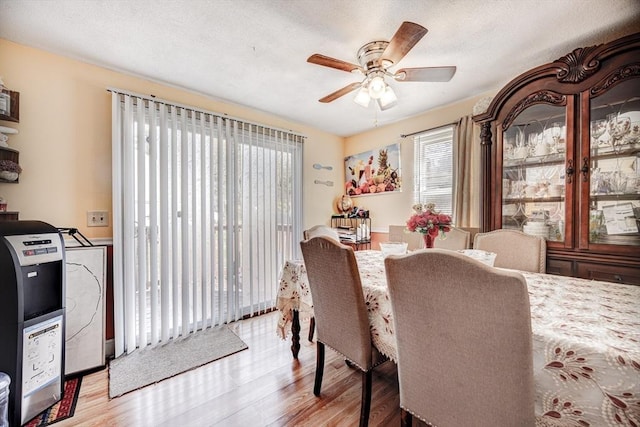 dining area with a ceiling fan and wood finished floors