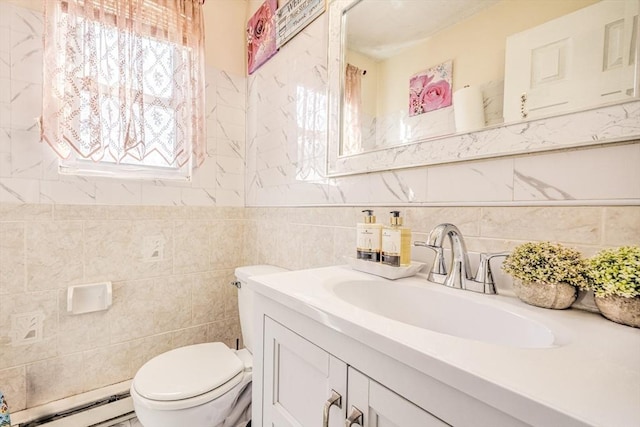 bathroom with vanity, a baseboard radiator, toilet, and tile walls