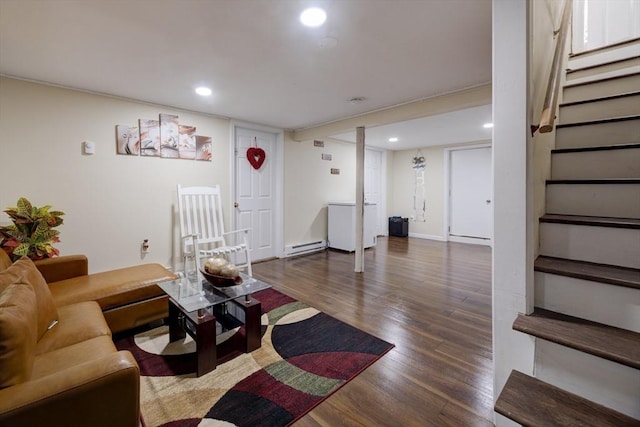 living room featuring baseboard heating, recessed lighting, wood finished floors, and stairway