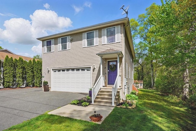 3 Birch Ave, East Longmeadow, MA 01028 - traditional-style house featuring asphalt driveway, an attached garage, and a front yard