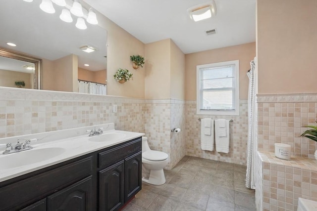 3 Birch Ave, East Longmeadow, MA 01028 - bathroom with tile walls, toilet, tile patterned flooring, double vanity, and wainscoting