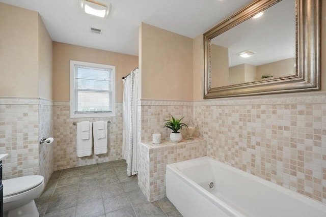 3 Birch Ave, East Longmeadow, MA 01028 - full bath with tile walls, a garden tub, a wainscoted wall, toilet, and tile patterned floors