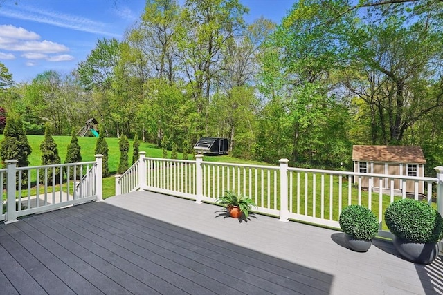 3 Birch Ave, East Longmeadow, MA 01028 - wooden deck featuring a lawn, an outdoor structure, a storage unit, a playground, and view of wooded area