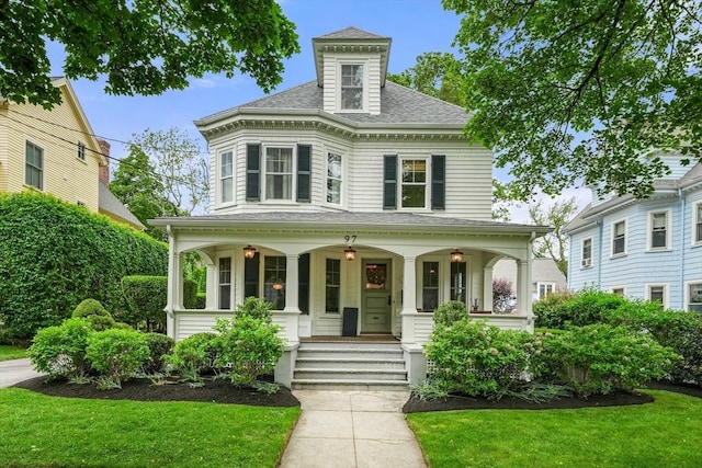 97 Manet Rd, Newton, MA 02467 - view of front of house with a porch, a shingled roof, and a front lawn