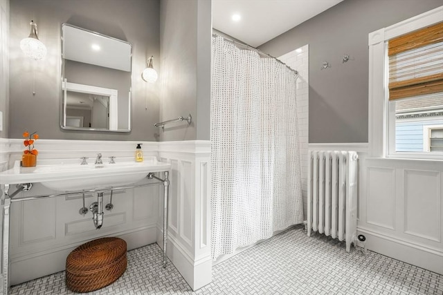 97 Manet Rd, Newton, MA 02467 - full bathroom featuring radiator, a decorative wall, a wainscoted wall, a shower with curtain, and vanity