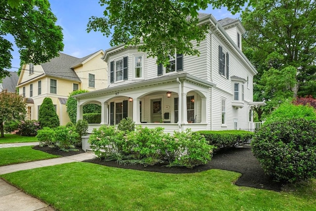 97 Manet Rd, Newton, MA 02467 - view of front facade featuring a porch and a front yard