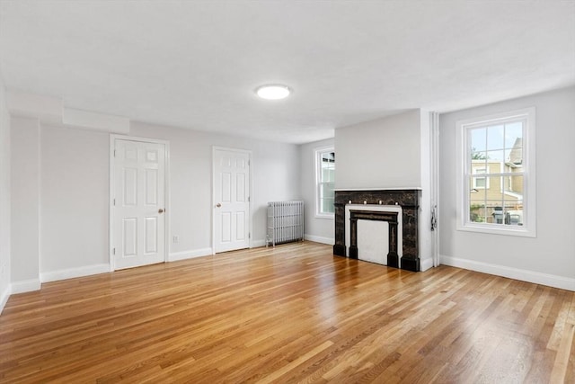 unfurnished living room featuring a fireplace and light wood-type flooring