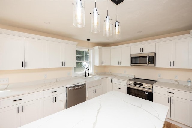 21 Seattle St, Worcester, MA 01604 - kitchen featuring stainless steel appliances, white cabinetry, decorative light fixtures, and light stone countertops
