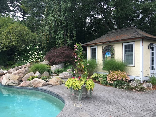 view of pool featuring an outdoor structure and a patio area