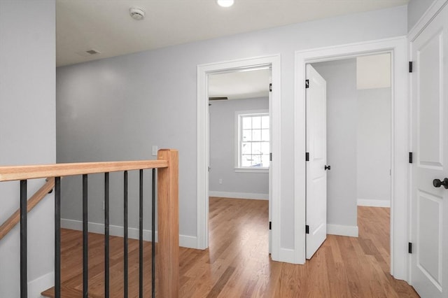 117 Montvale Ave, Woburn, MA 01801 - hall featuring an upstairs landing, wood finished floors, and baseboards