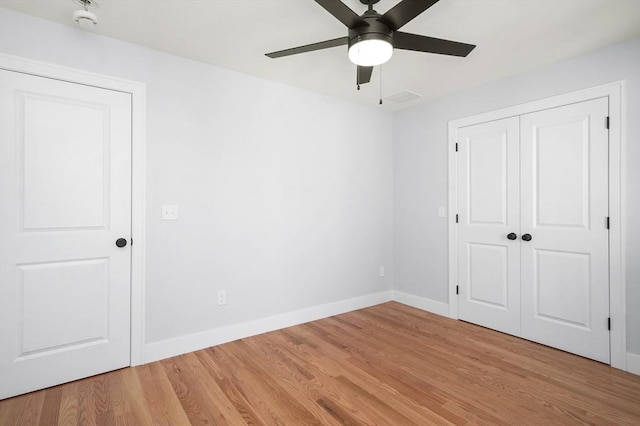 117 Montvale Ave, Woburn, MA 01801 - unfurnished bedroom featuring light wood-style flooring, baseboards, a closet, and a ceiling fan