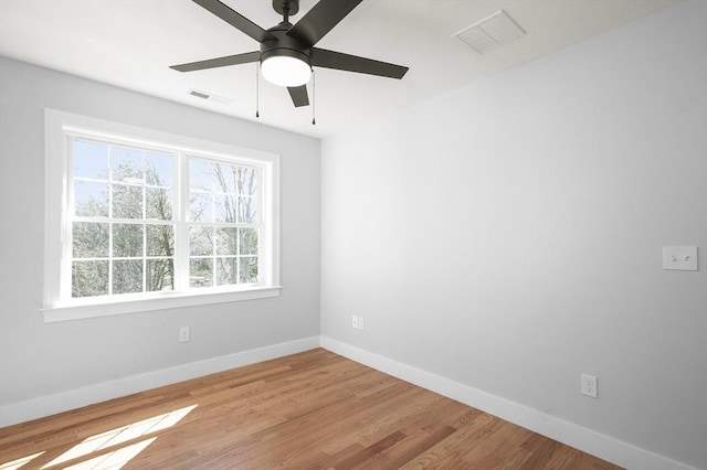 117 Montvale Ave, Woburn, MA 01801 - empty room with plenty of natural light, baseboards, light wood finished floors, and ceiling fan
