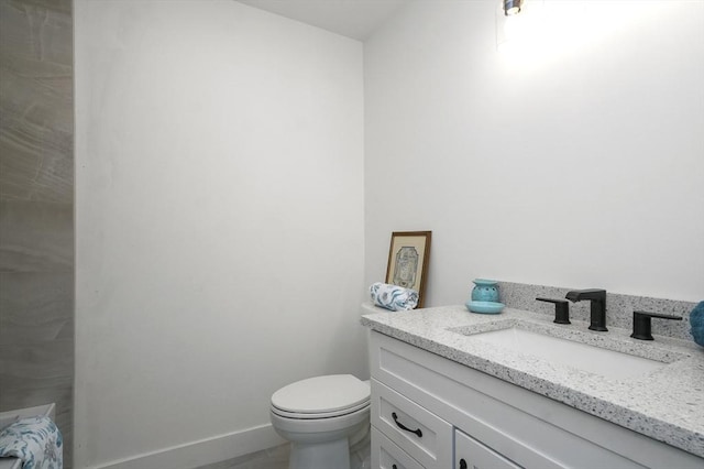 117 Montvale Ave, Woburn, MA 01801 - bathroom with toilet, vanity, and baseboards
