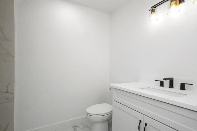 117 Montvale Ave, Woburn, MA 01801 - bathroom with marble look tiles, vanity, toilet, and baseboards